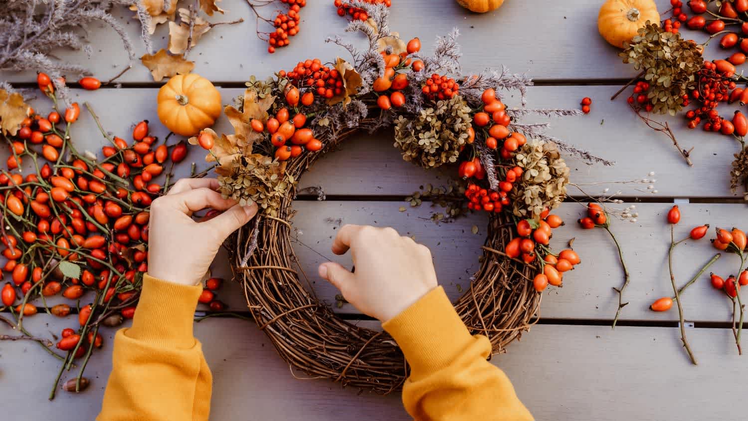 Girl making floral autumn door