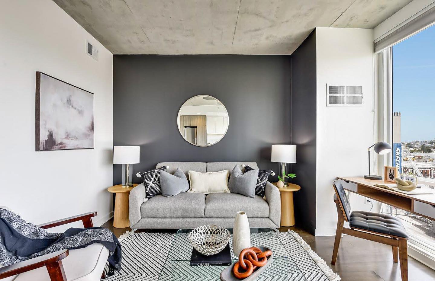 Grey wall with round mirror