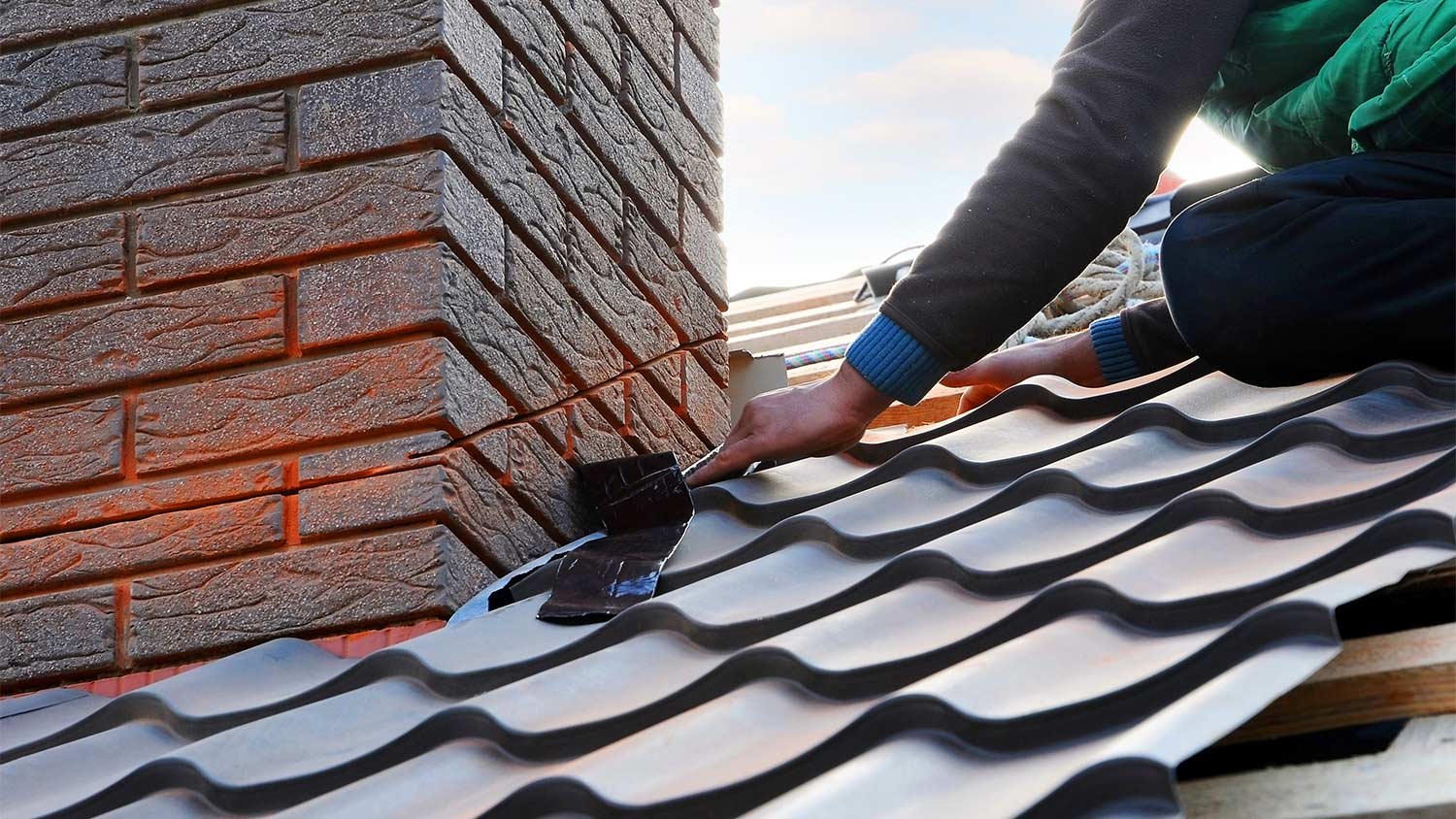 Worker attaching covering to roof.