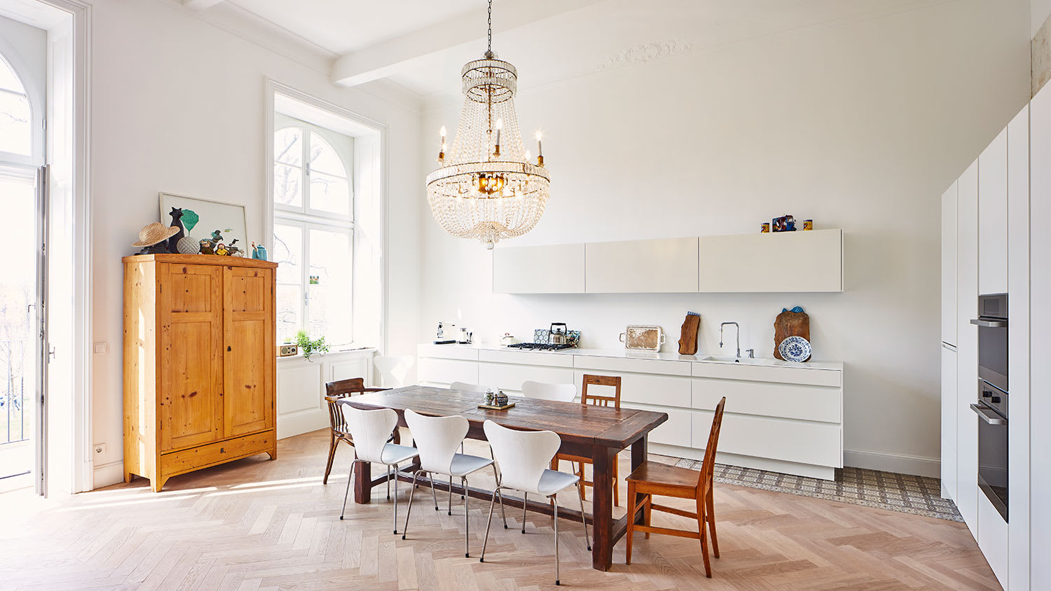 A chandelier hangs in a kitchen