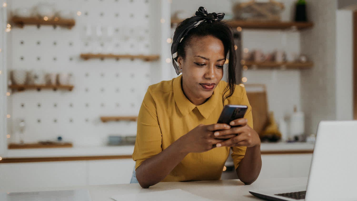 A young woman checking her credit score on her mobile phone