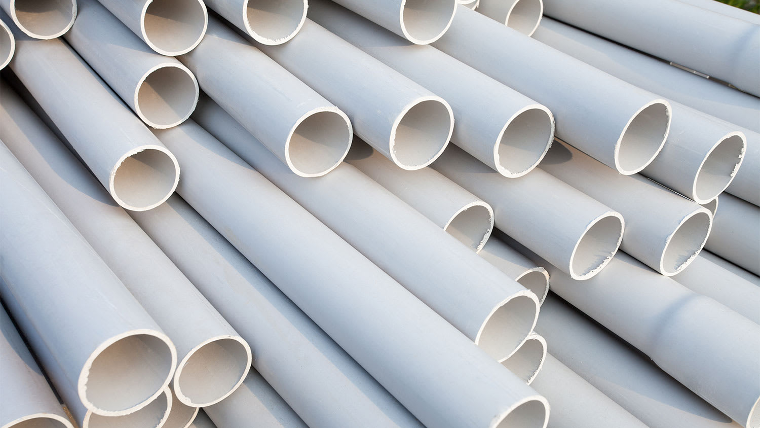 A view of a pile of white PVC pipes