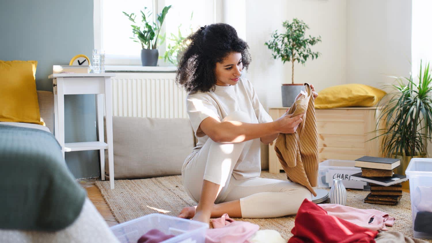 woman sorting wardrobe indoors at home