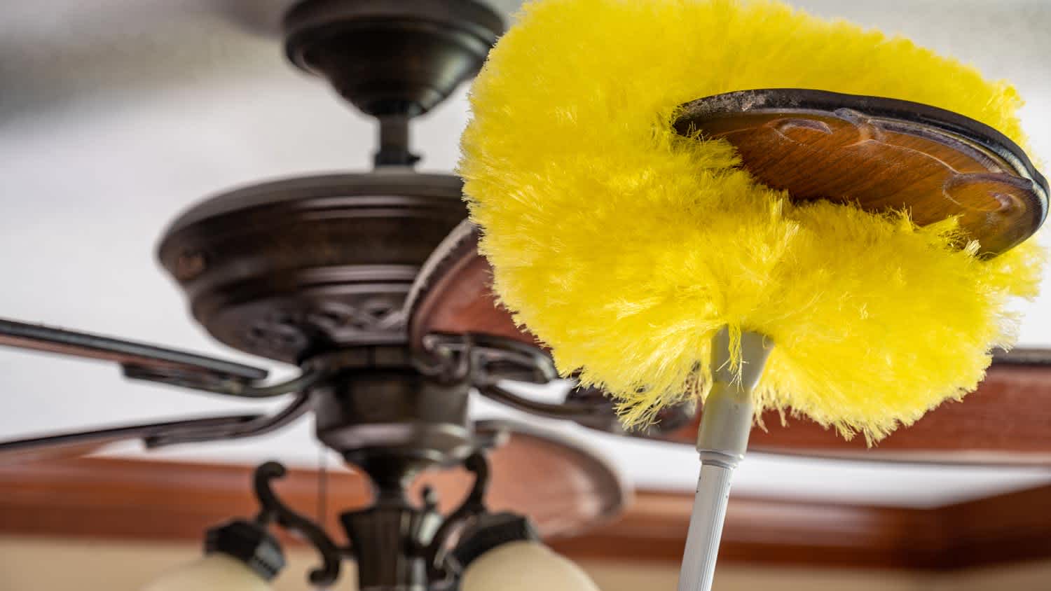 Cleaning a ceiling fan by using a telescoping pole