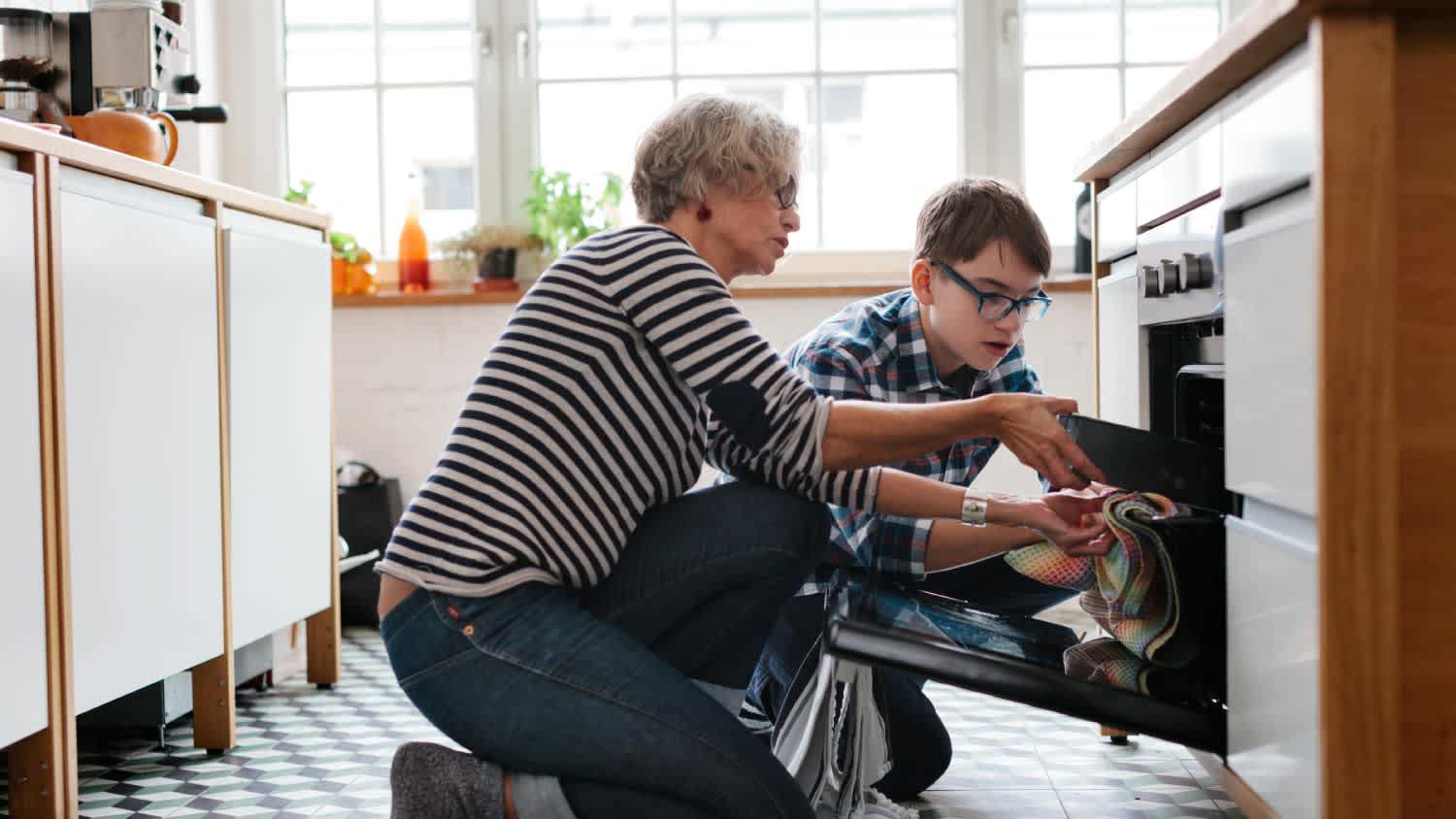 Mother teaching her son how to bake