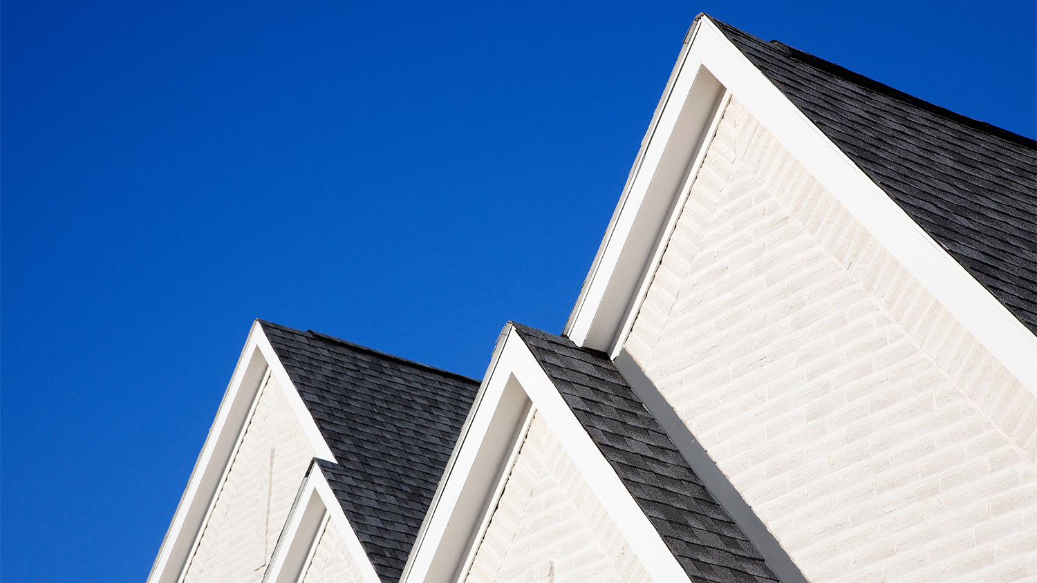 Gray roof on white house