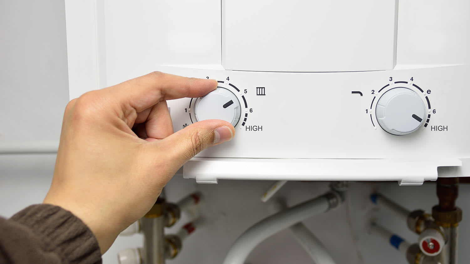 Hand adjusting temperature of a water heater