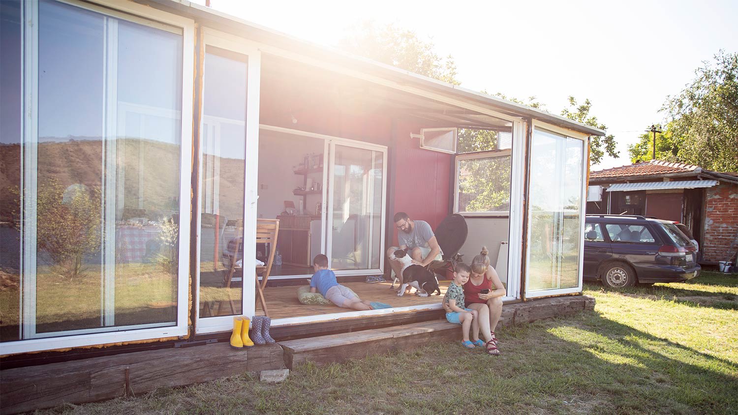 A family lounges in a shipping container home