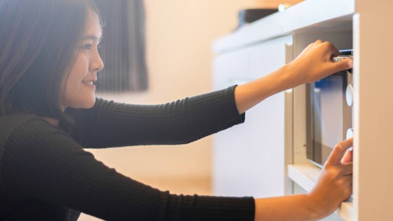 Woman programming microwave