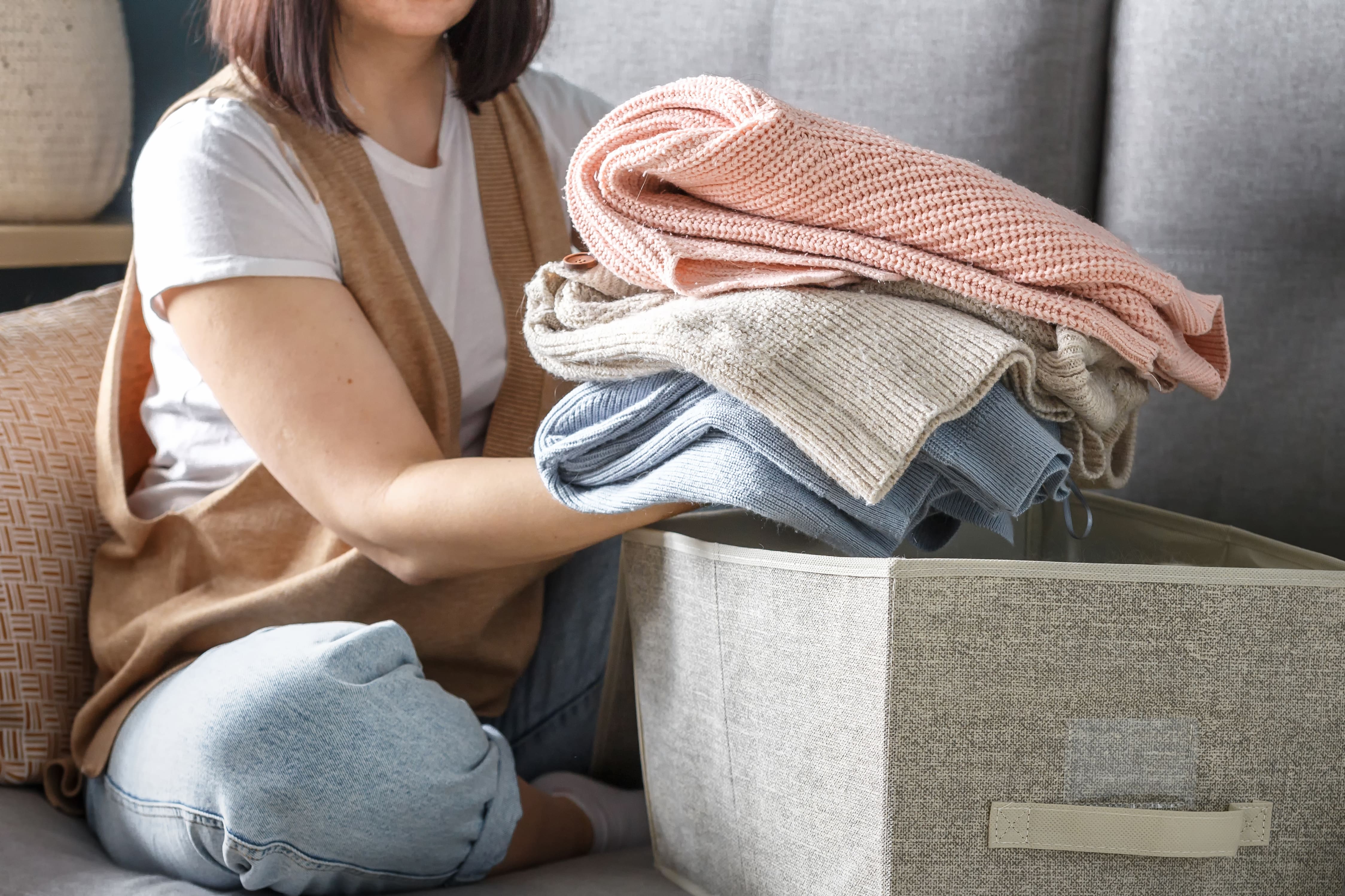 A person storing sweaters for spring