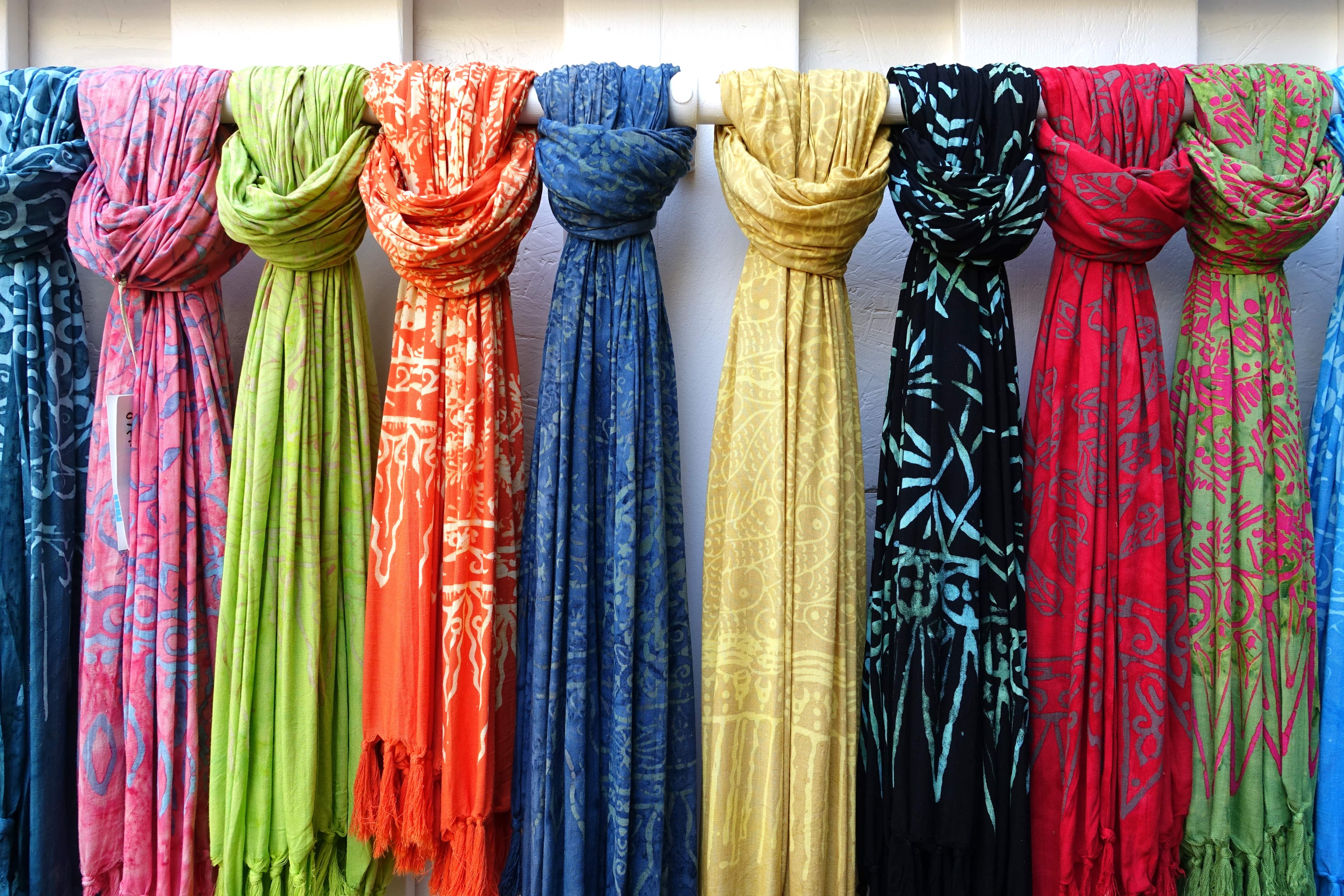 Colorful scarves on a hanging bar