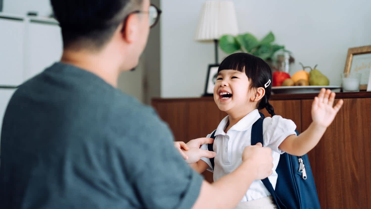 Girl getting dressed with her father