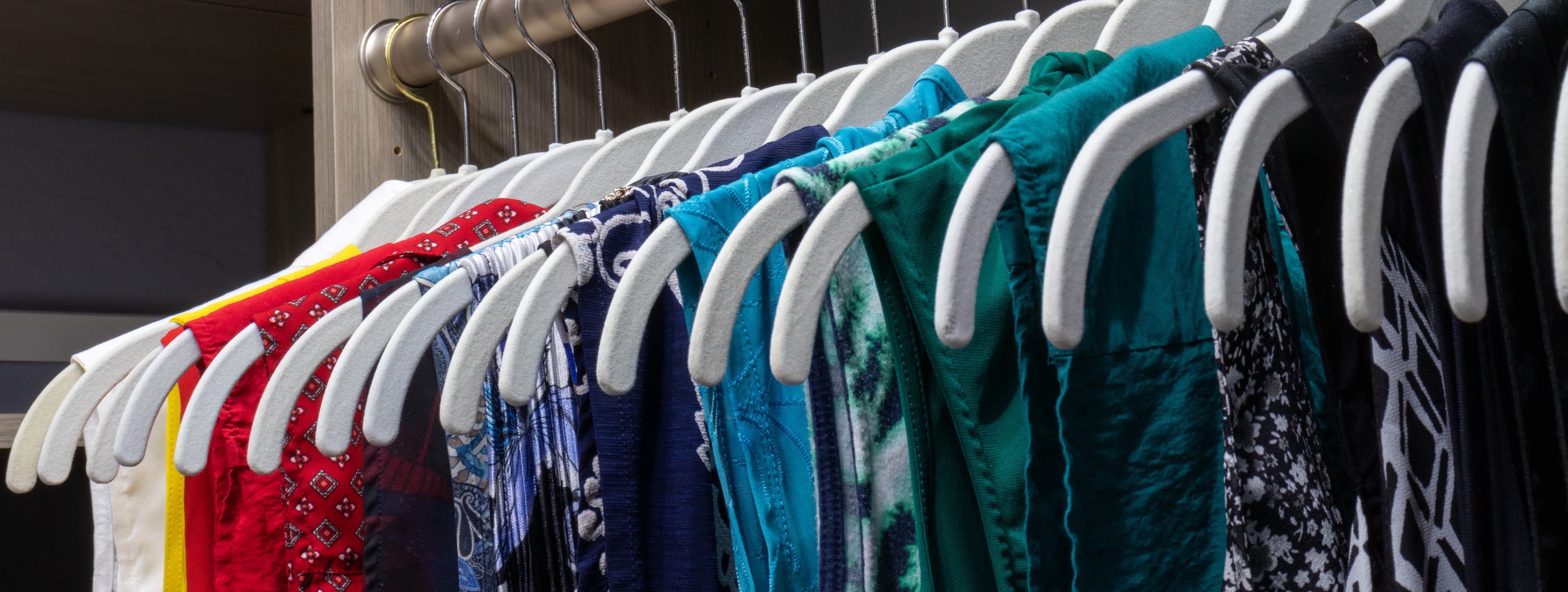 Colorful clothes hanging on velvet hangers