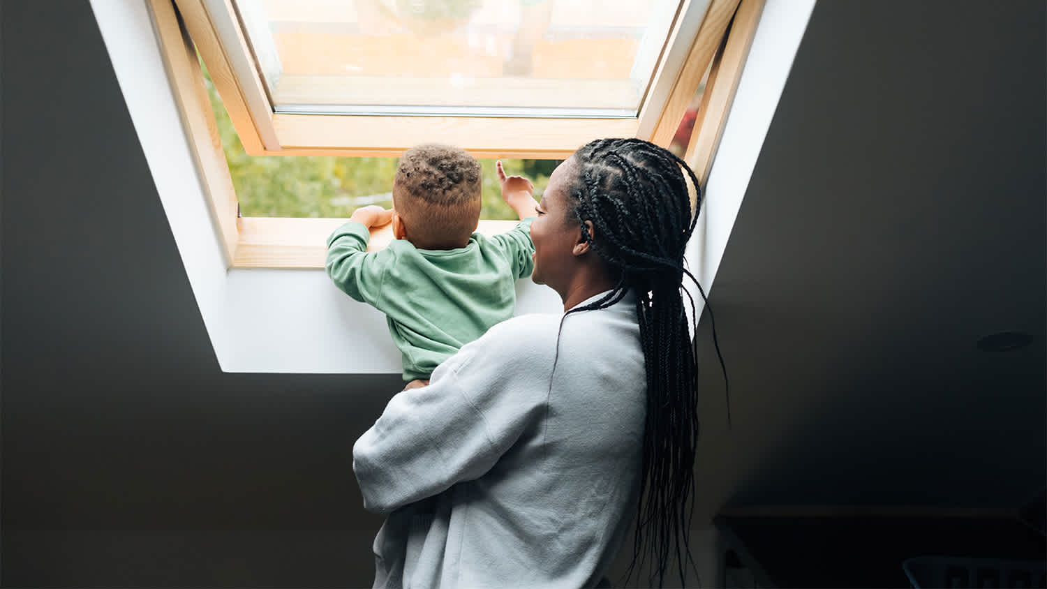 Mother and baby open window fresh air