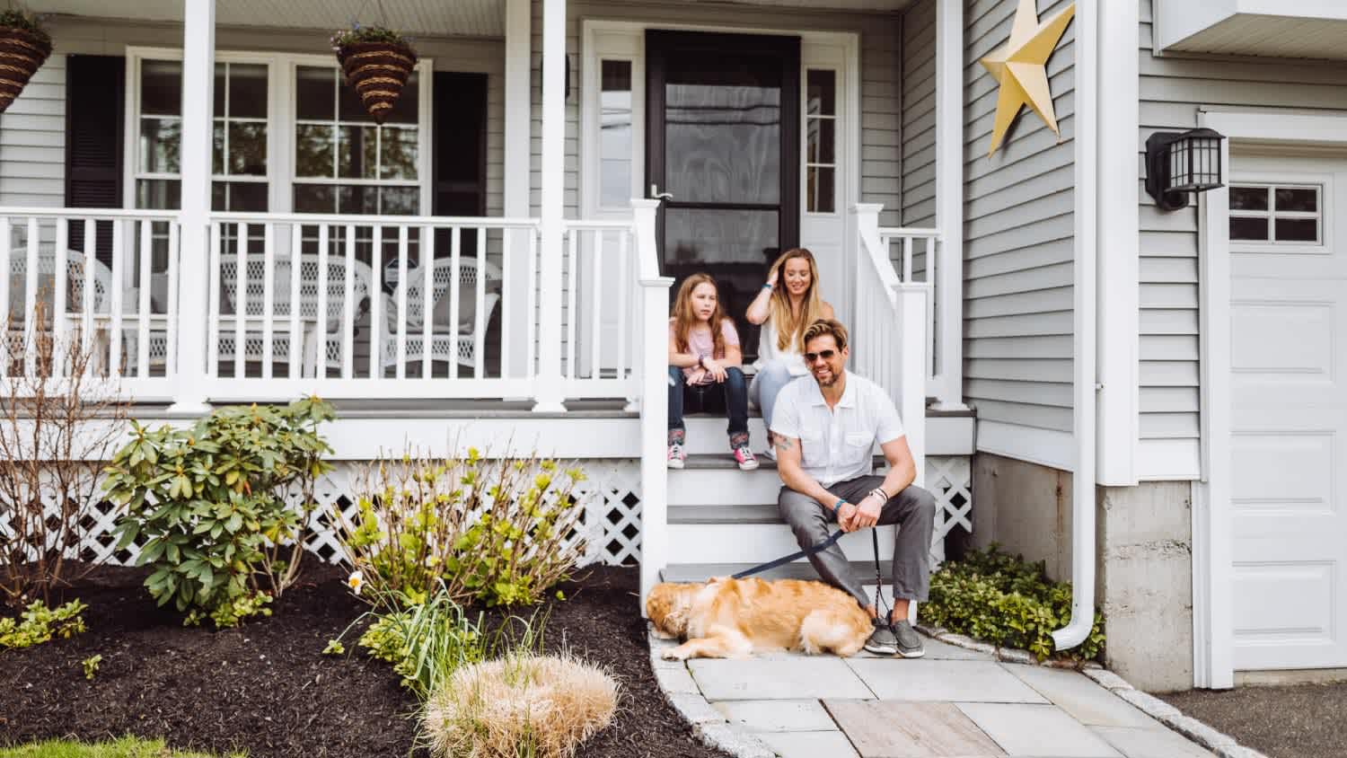 Family sitting in front of home