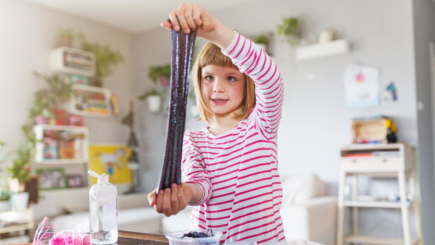 Little girl making homemade slime toy