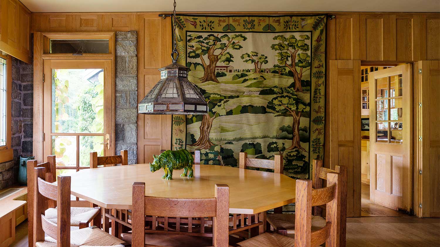 A view of a dining room with a hanging tapestry