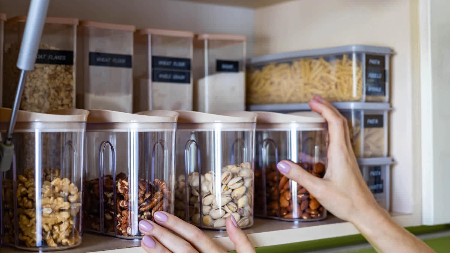 Woman organizing kitchen cabinets