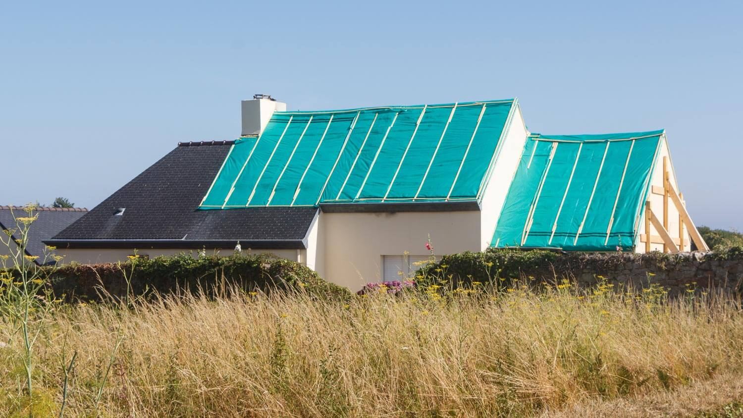 A house roof covered with tarp
