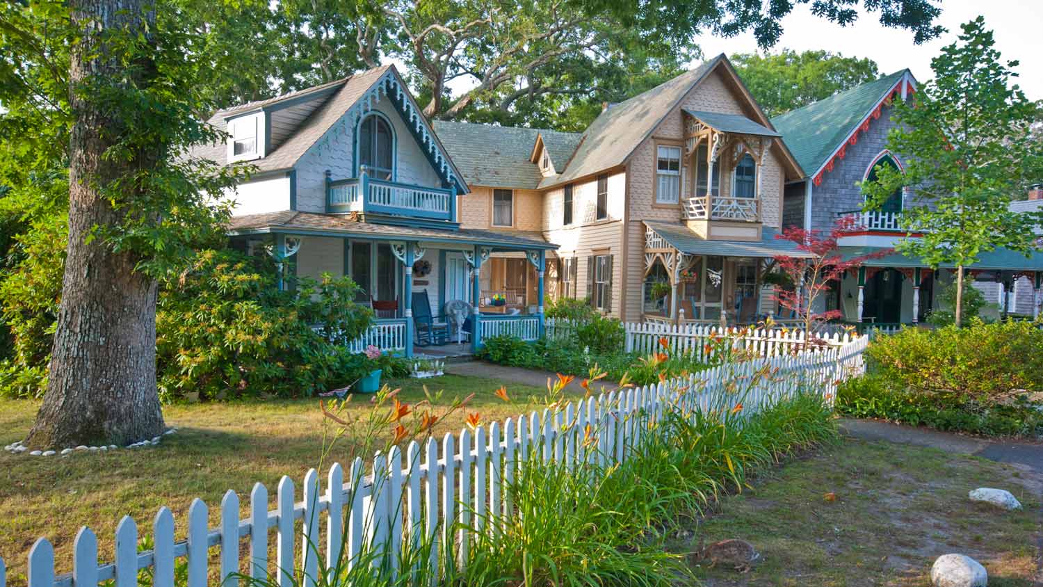 Array of victorian cottages with white picket fences