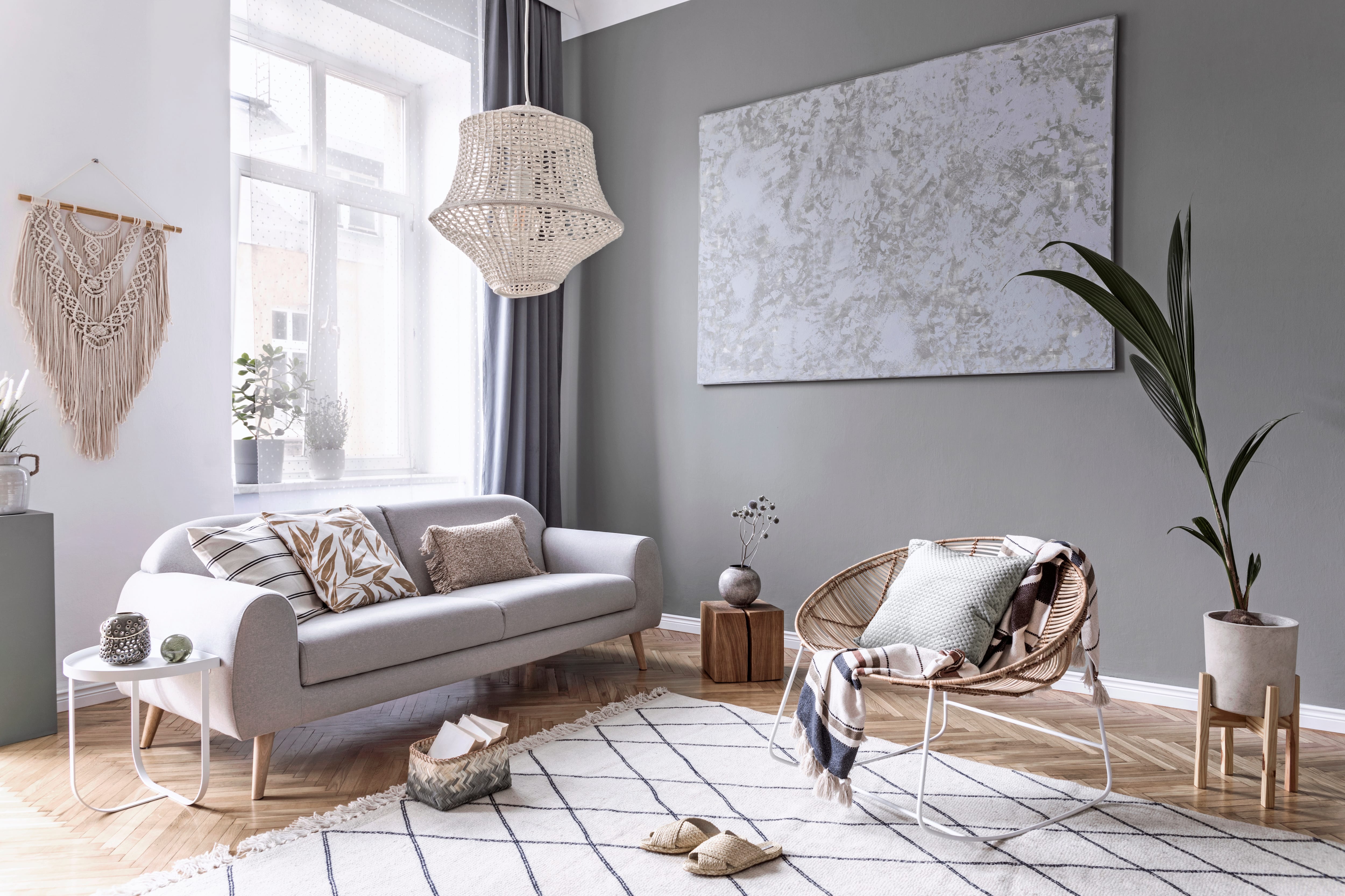 A modern living room with boho elements and a rattan chandelier