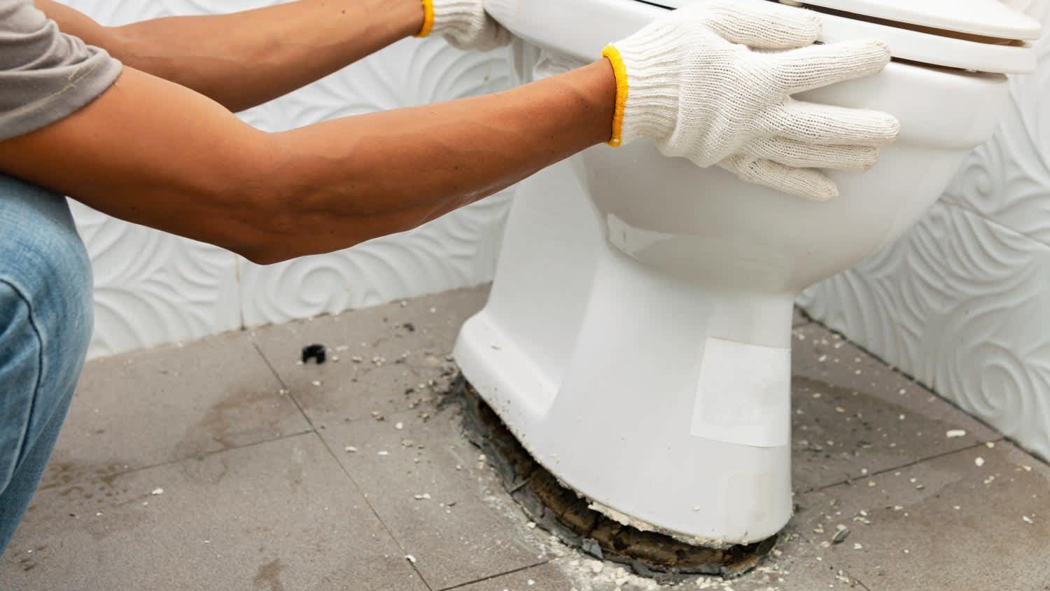 Worker removing toilet