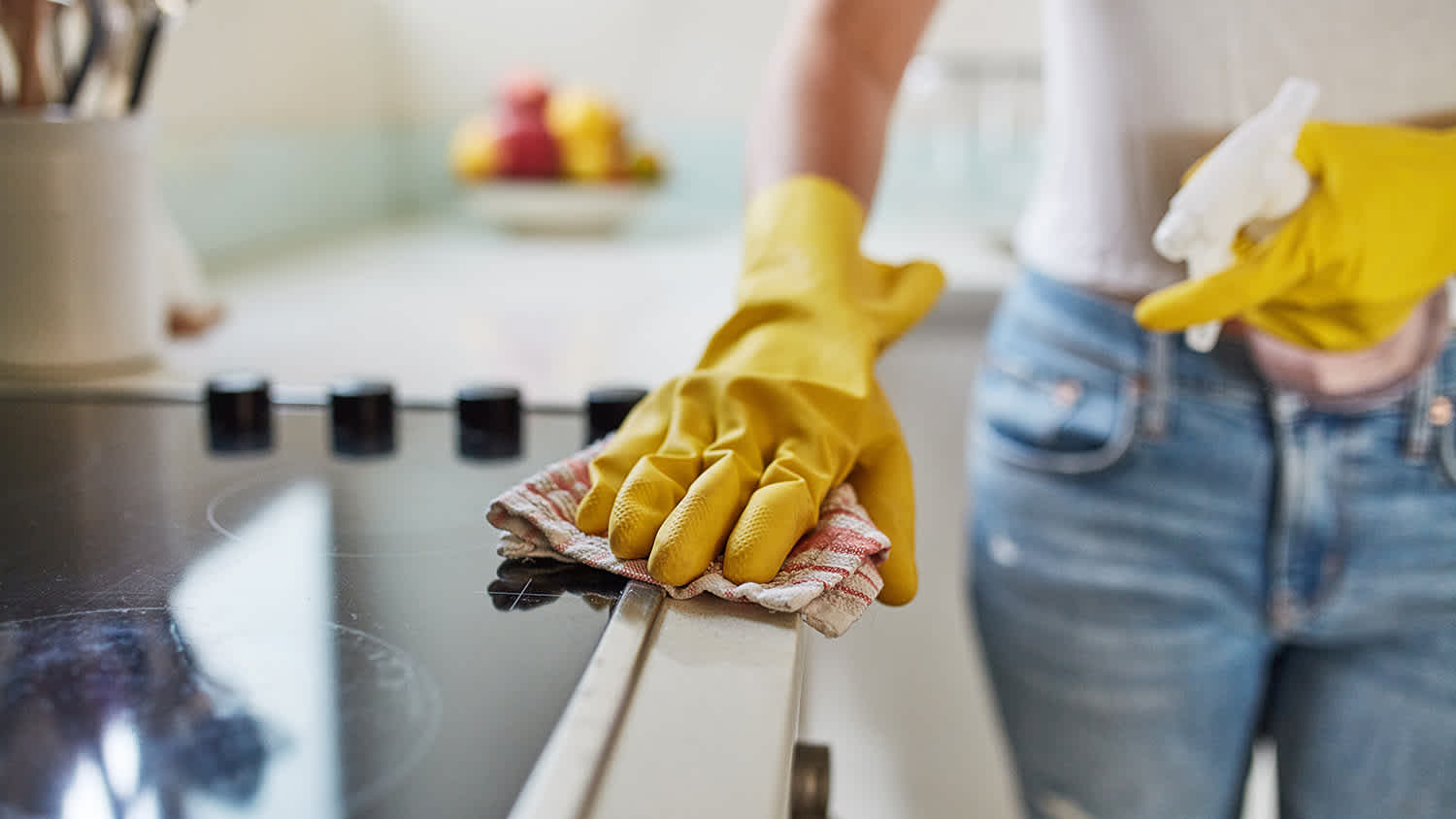woman cleaning stovetop