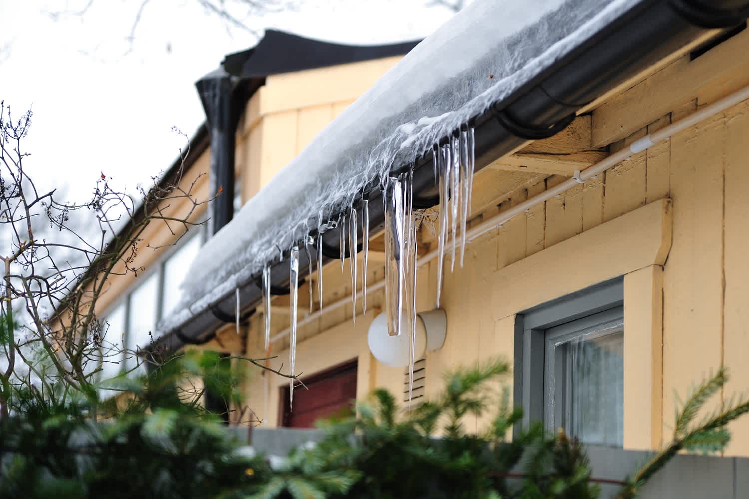 Ice gutters melting from a house roof