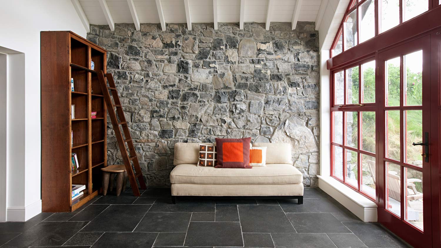 A living room with stone flooring