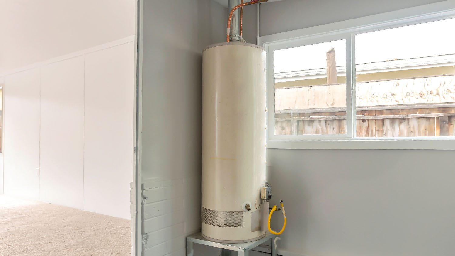 Storage tank water heater in a laundry room