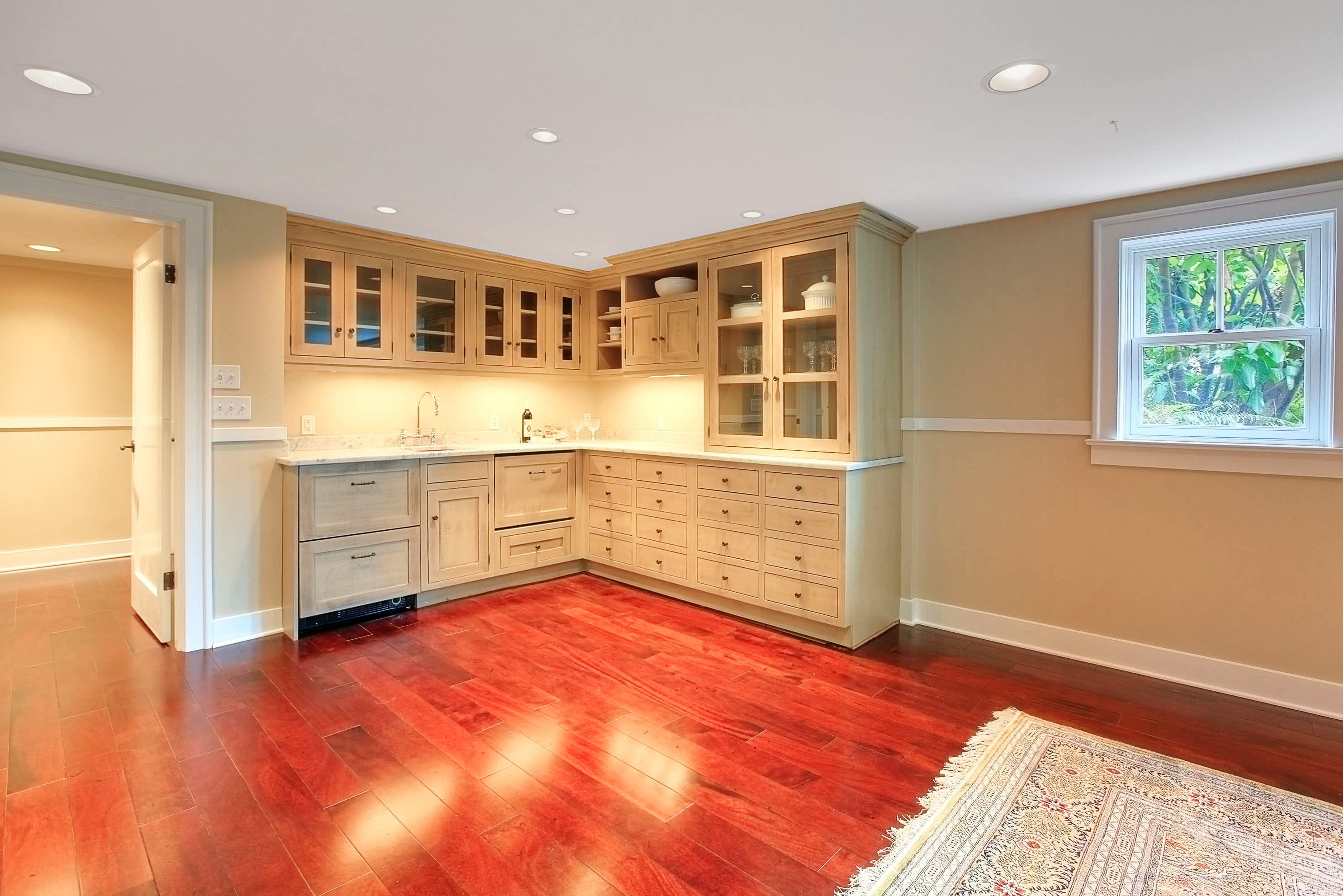 Basement kitchenette with light cabinetry