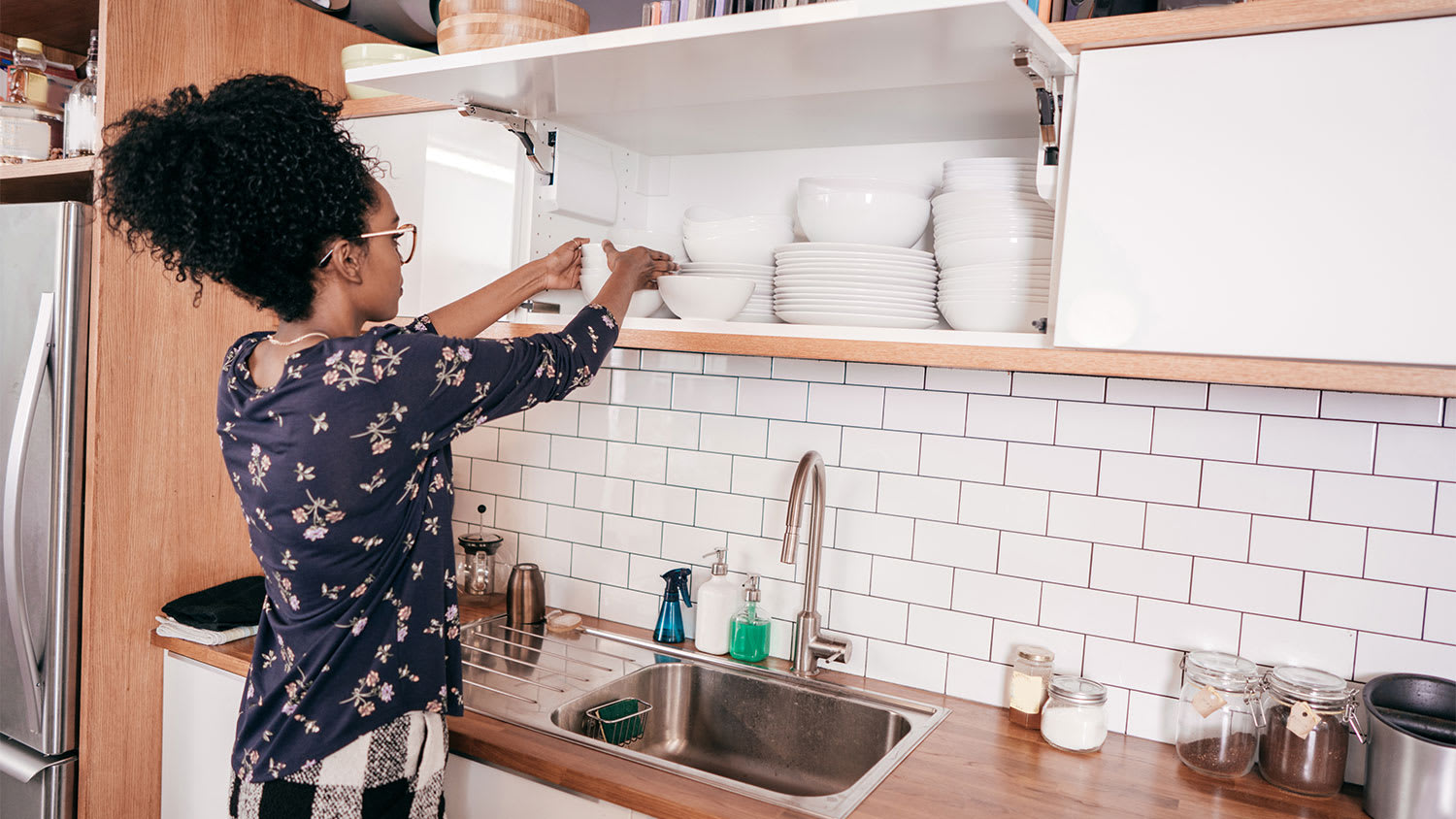 A woman organizes her kitchen