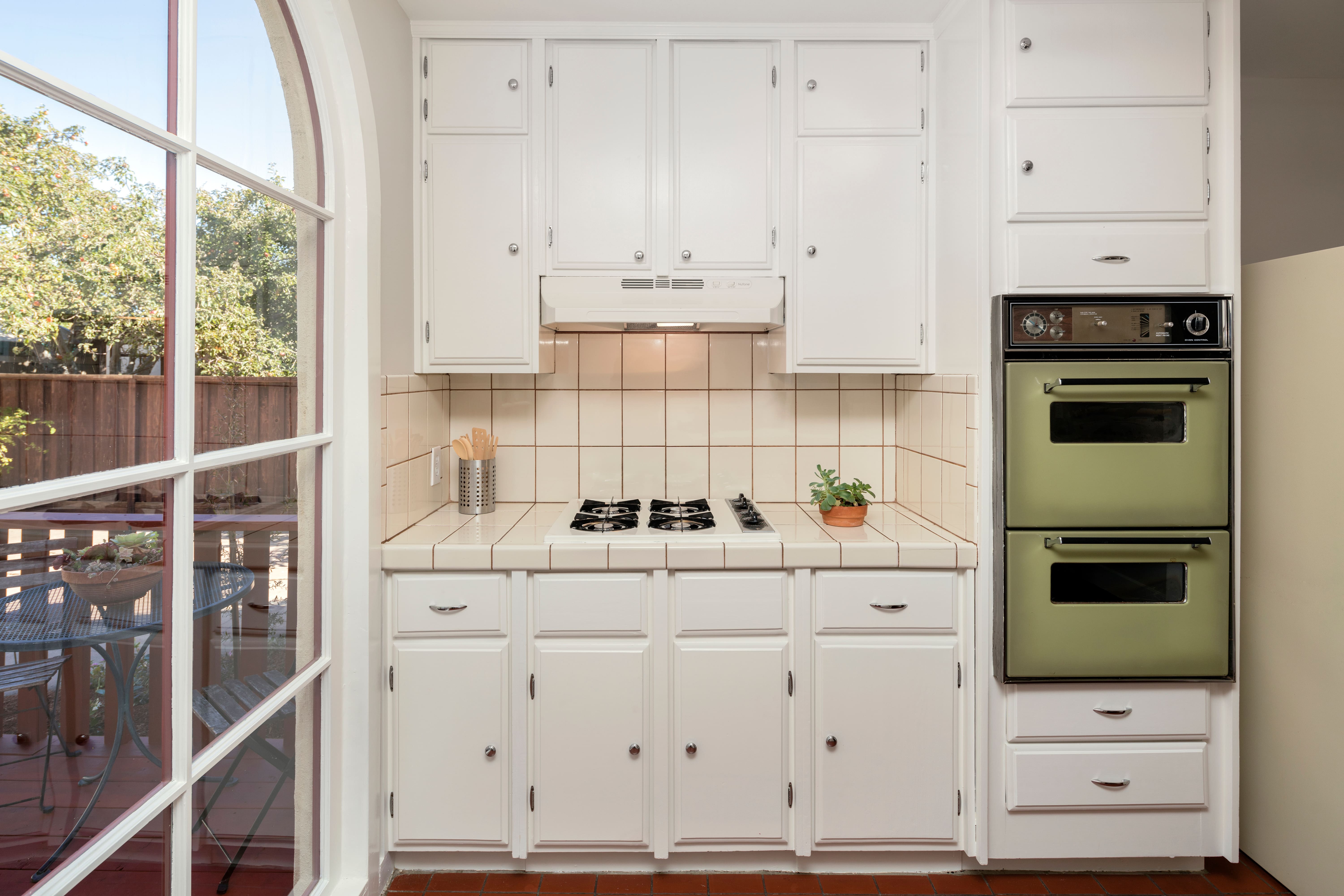 Kitchenette with double wall ovens built into cabinetry
