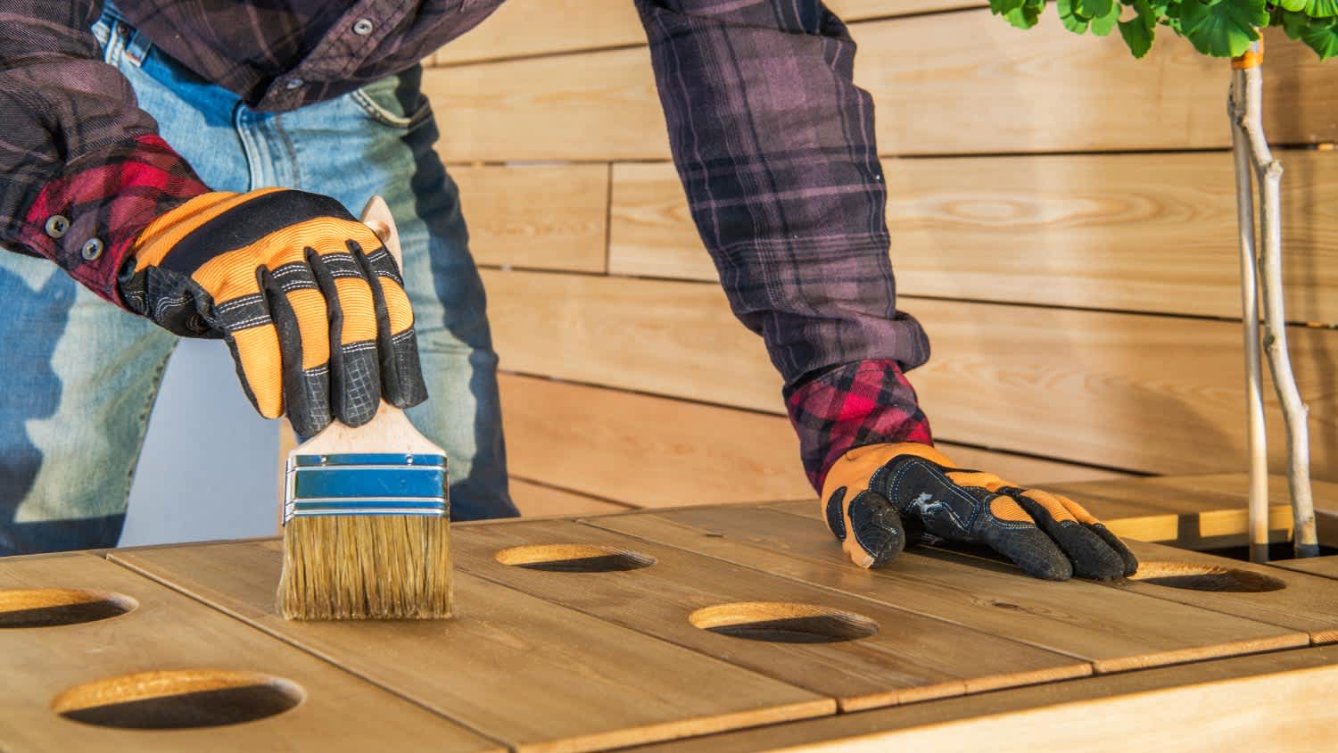 A man applying polyurethane
