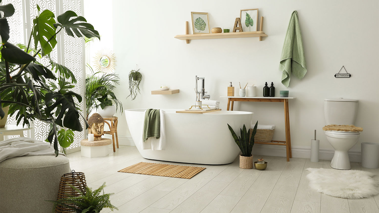 A view of a white bathroom with plants