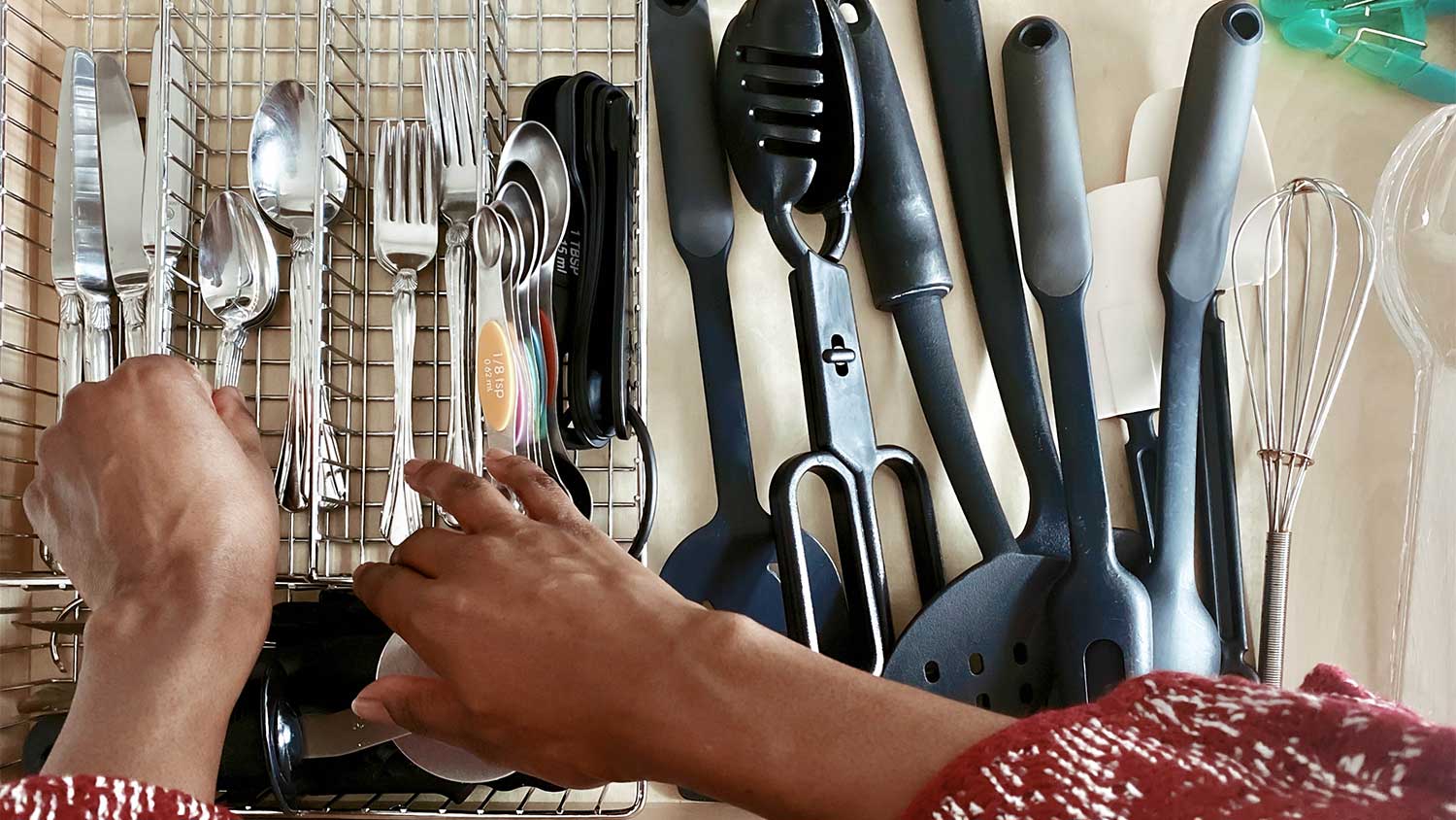 A woman organizes utensils