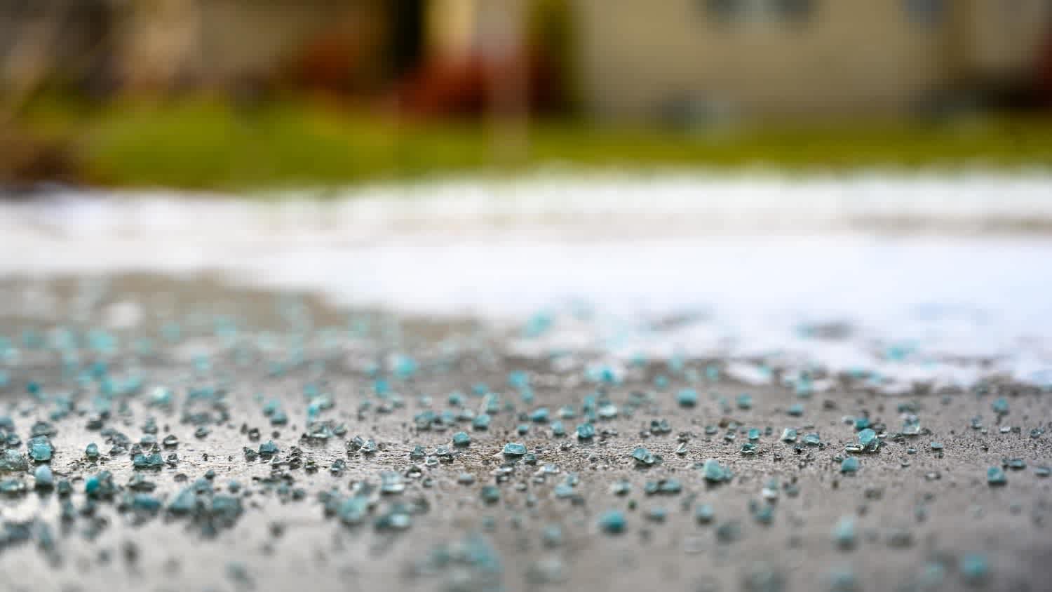 Rock salt ice-melt on concrete with snow