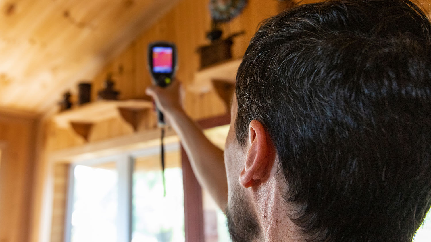 A man uses a thermal imaging camera