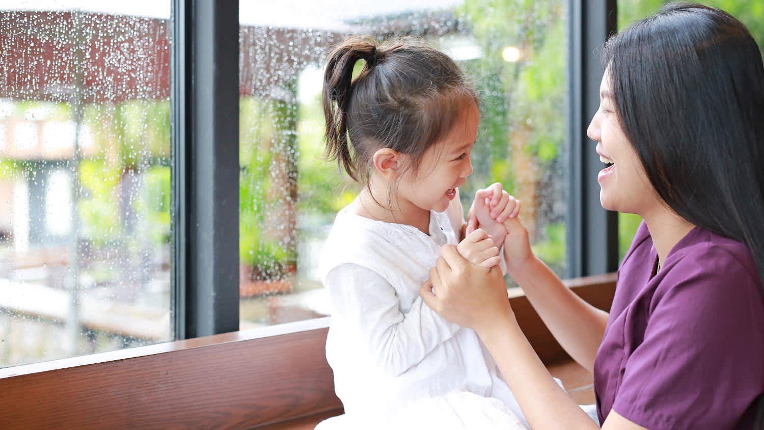 Mother and her daughter playing