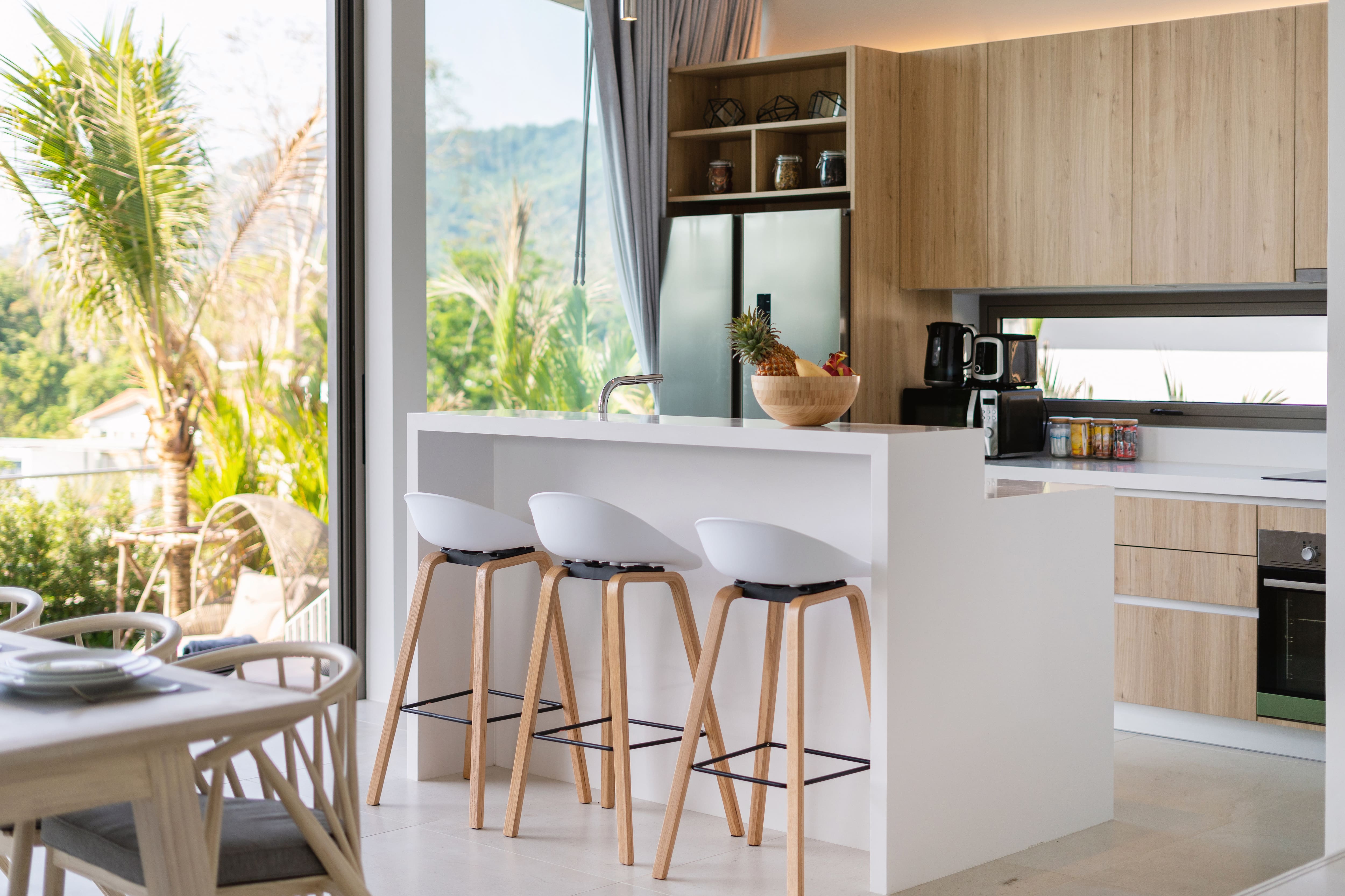 A sunny breakfast bar with a sink and setting that could convert to a wet bar for parties