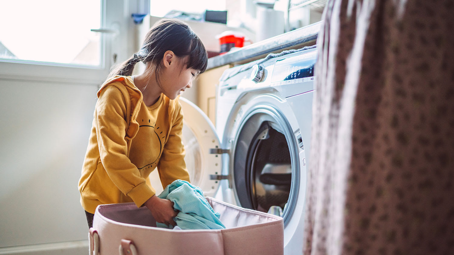 Child loading washing machine