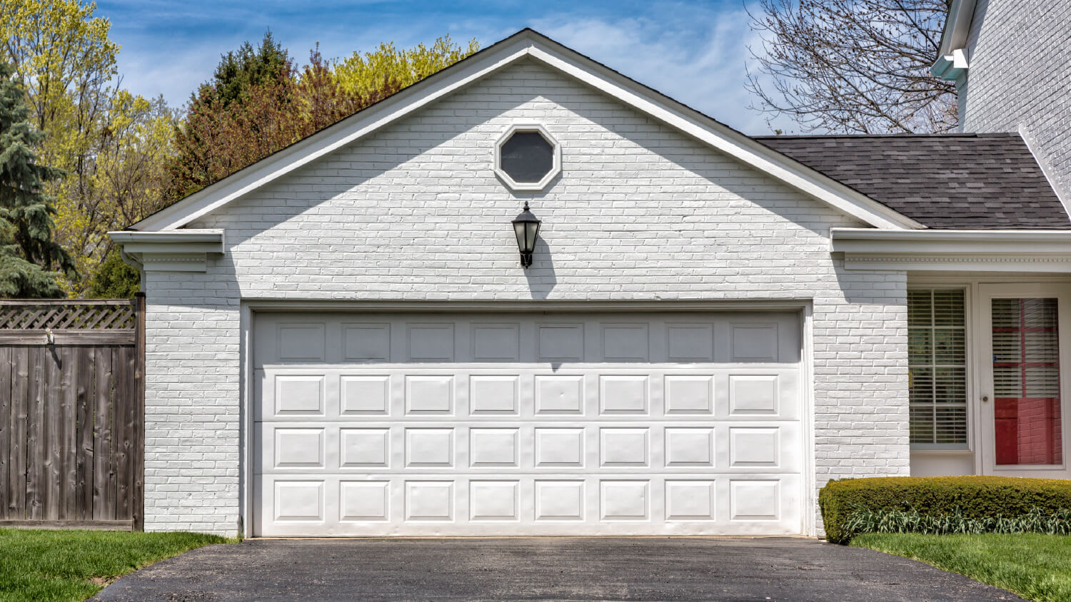 white fiberglass garage door on white brick house