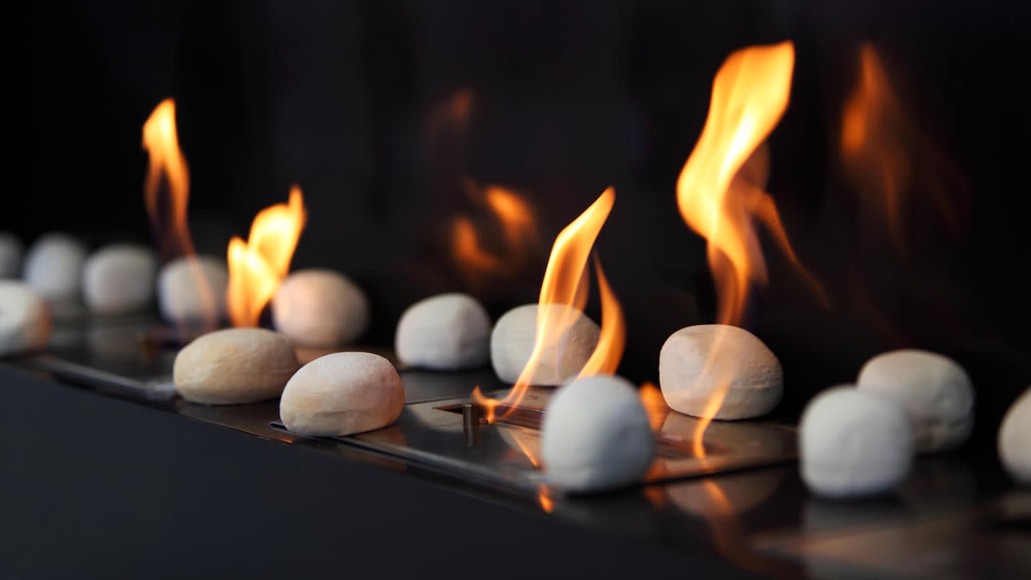 Close-up of a gas fireplace with white round stones