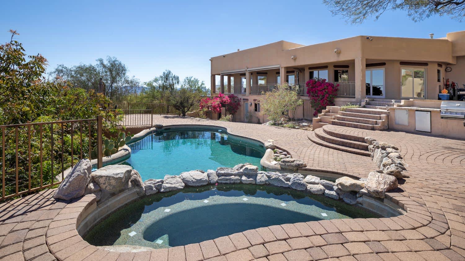 Swimming pool with hot tub and terraced patio