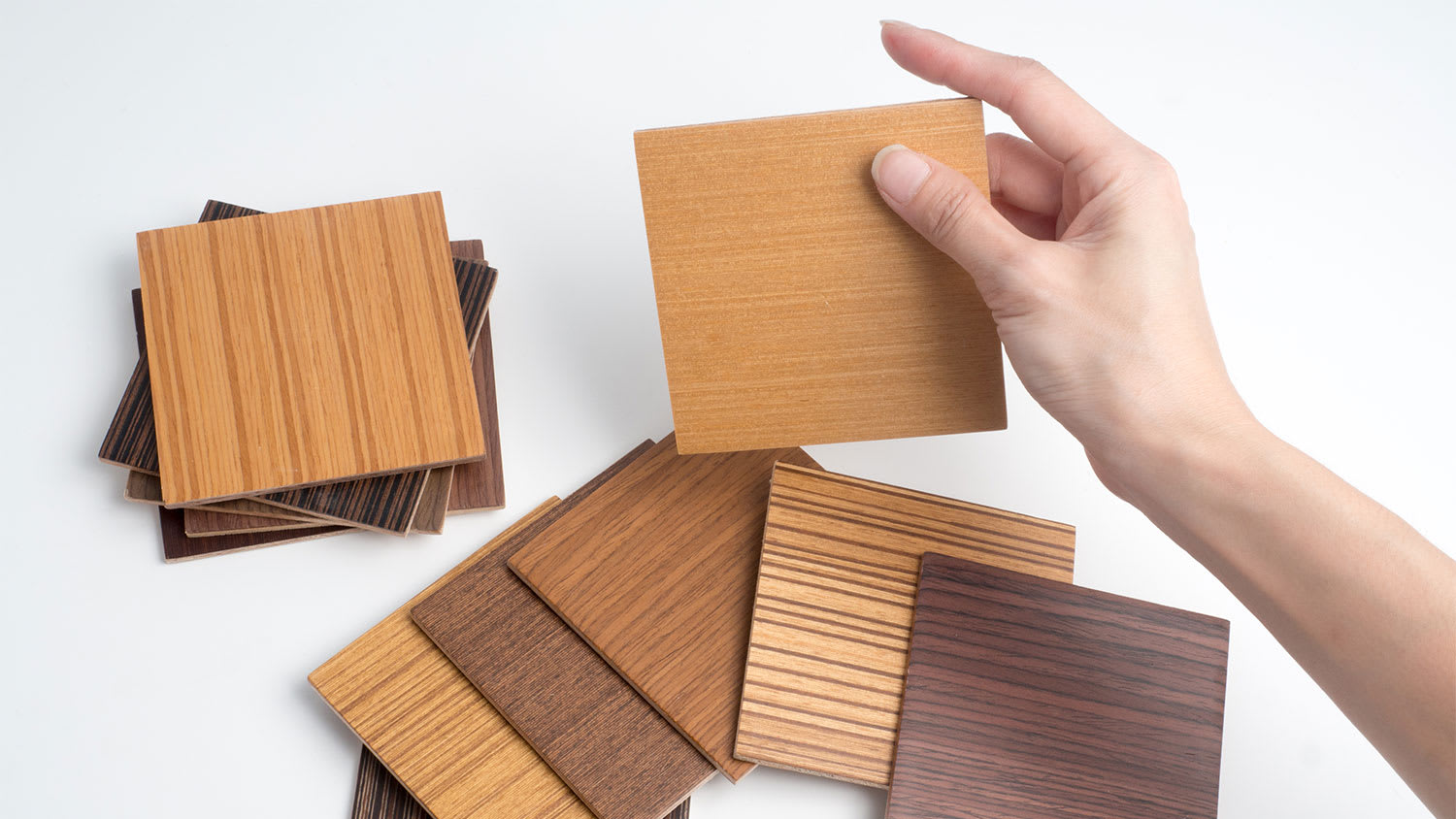 person holding veneer wood floor samples