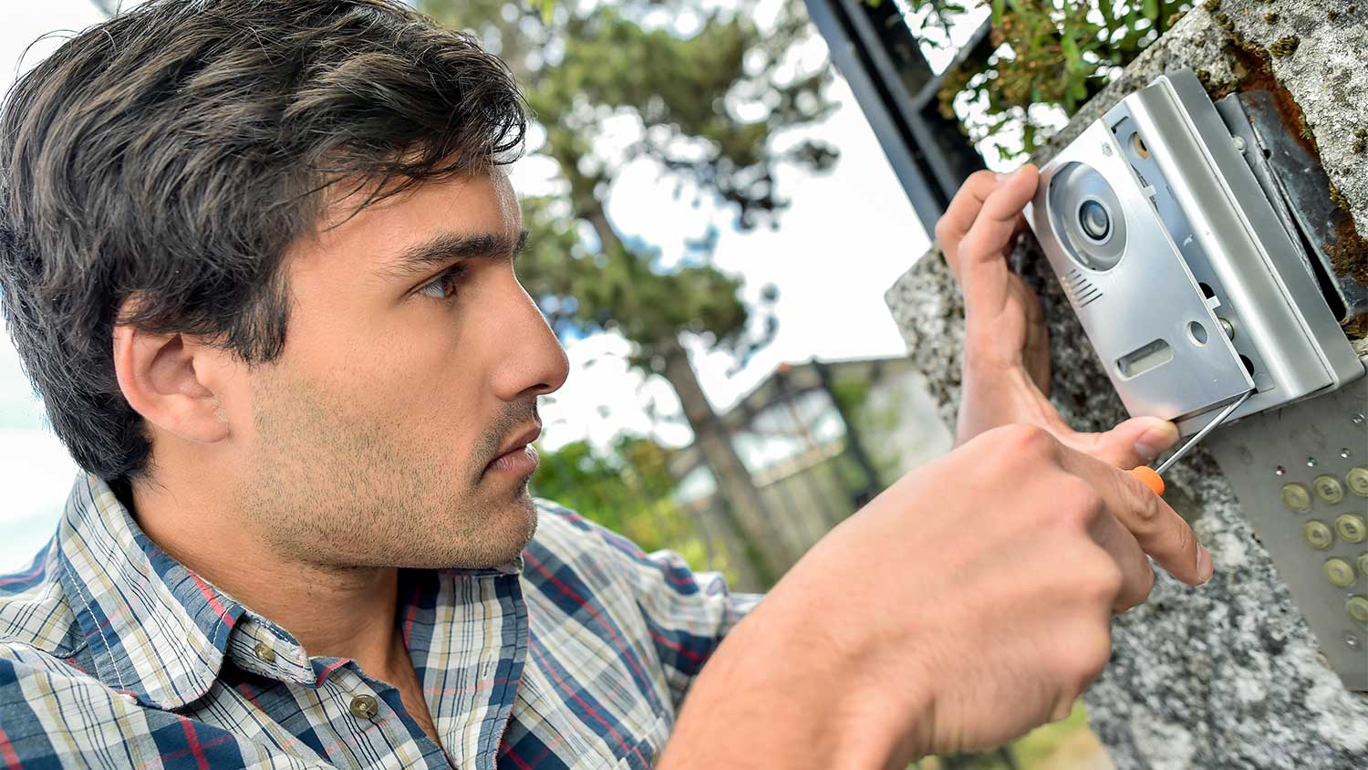 A man installs a doorbell
