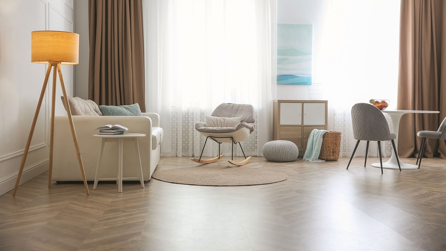 A view of a living room with herringbone laminate flooring