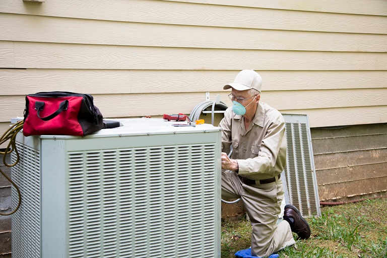 Man fixing air conditioner unite