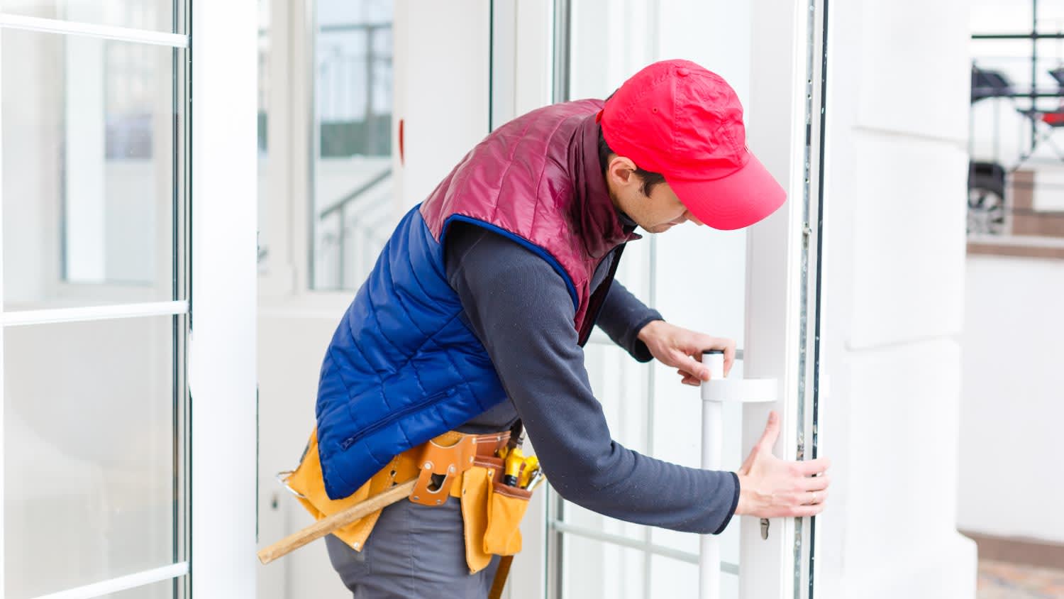 A repairman adjusting a terrace door