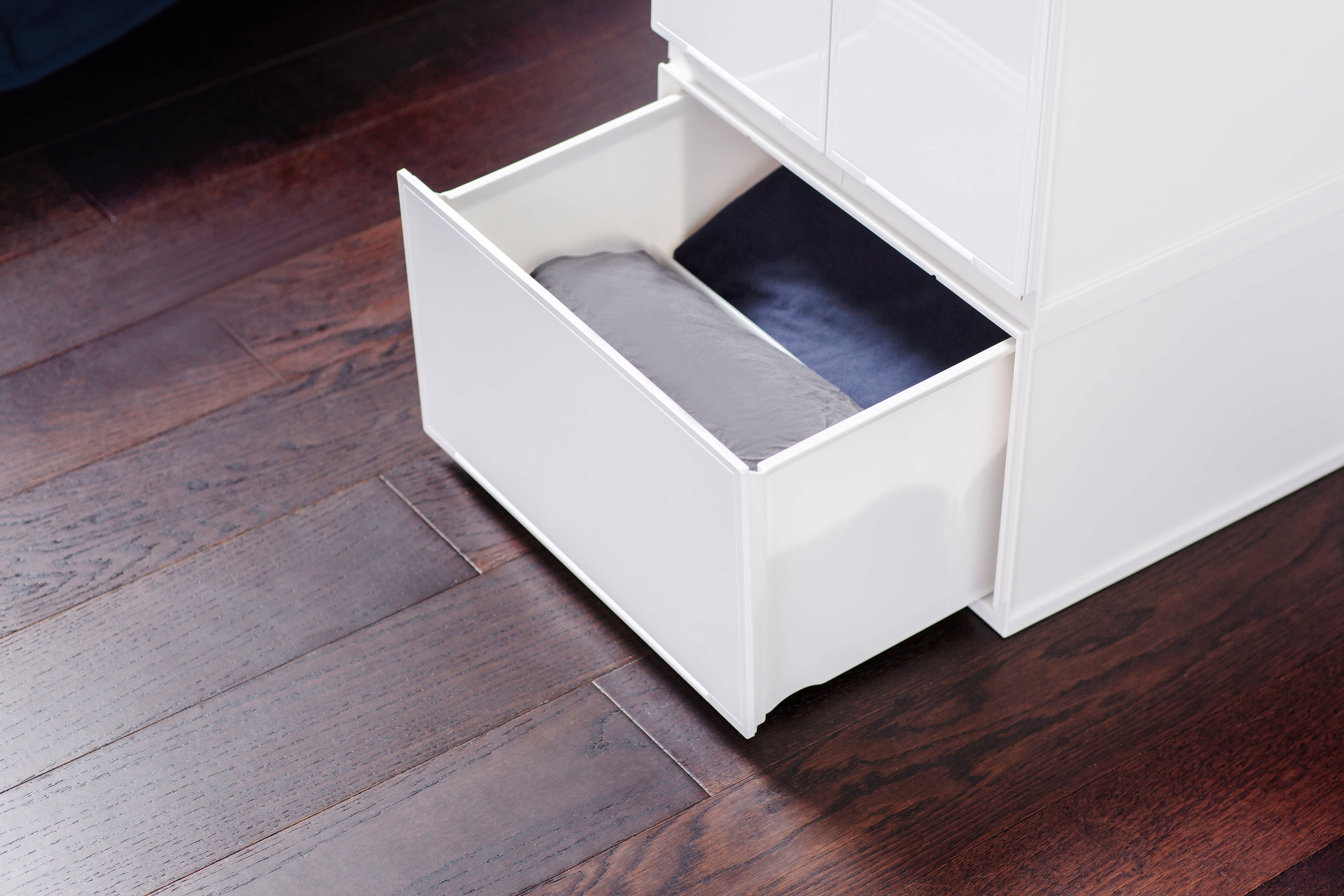 Two clear plastic drawers containing bedding